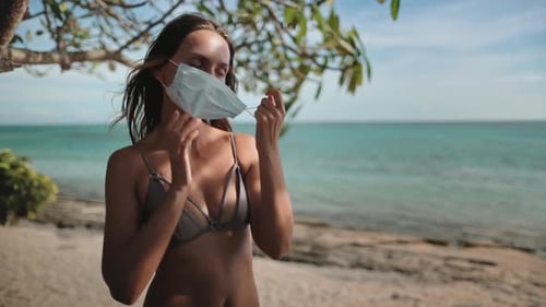 Young Woman Wearing Protective Face Mask Enjoying Tropical Beach