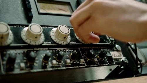 Sound engineer using digital audio mixer sliders Engineer pressing keys adds control panel volume