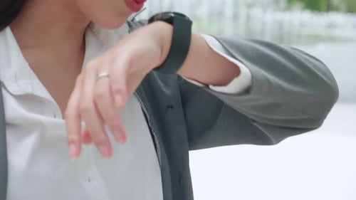 Woman Uses Smartwatch in Modern City Setting