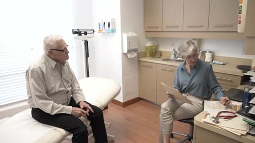 Doctor and Senior Patient Talking in Clinic Exam Room Adult