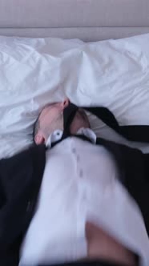 Tired Young Businessman in Suit Lying on Bed in Hotel Just Arrived Vertical Video