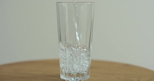 Water Being Poured Into a Clear Glass