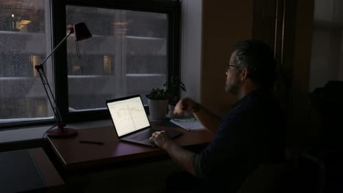 Businessman Working Late at Laptop in Dark Snowy Office 5054 Years
