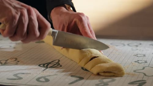 Hands Cutting Sweet Dough into Pastry Slices