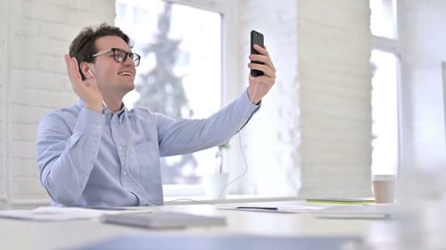 Young Adult Waves During Mobile Phone Video Call