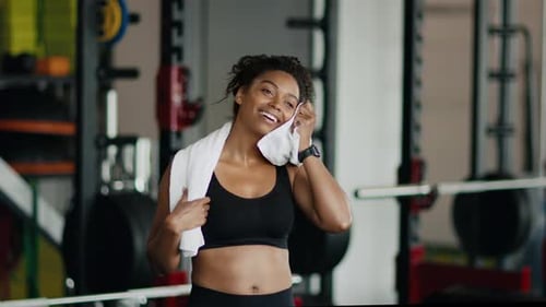 Smiling Woman Wipes Sweat After Gym Workout