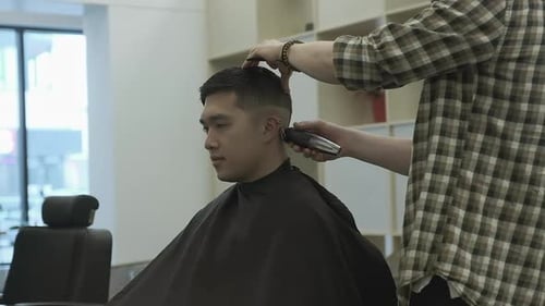 Man Getting Haircut at Modern Barbershop