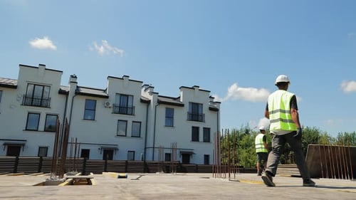 Construction Workers Walking on Urban Construction Site
