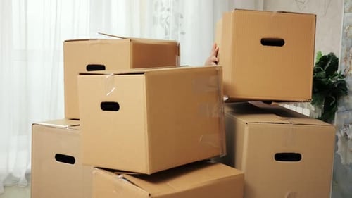 Family Moving Boxes Into A New House