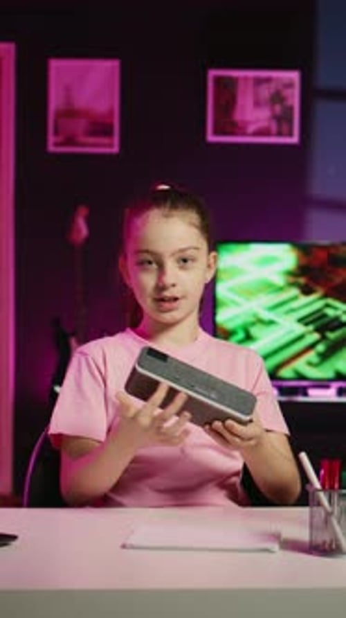 Child Demonstrating Tablet Game System at Desk