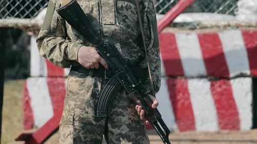 Soldier Holding Rifle Standing at Attention