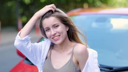 Driver Woman in Casual Clothes Outside Her Vehicle Leaning on the Hood Posing at Camera Lifestyle