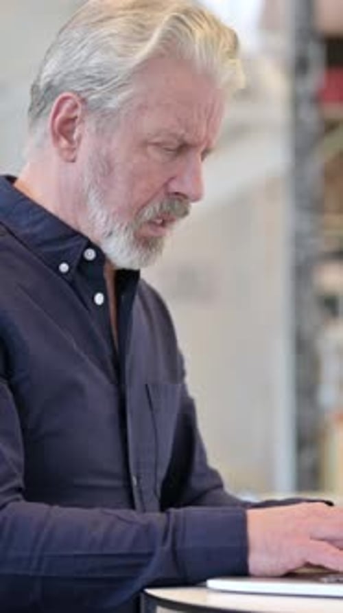 Coughing Old Man Using Laptop in Cafe, Cough, vertical video