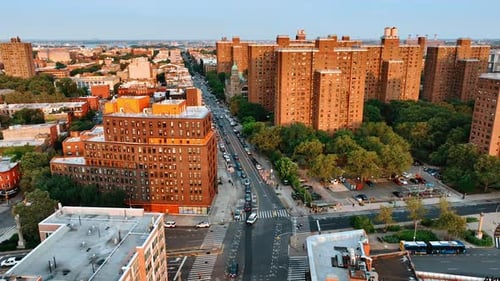 Orange brick wall facades of multistoried building reflecting sunlight at sunset.
