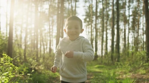 A Boy Runs on a Walk in the Park
