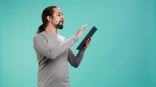 Man Using Tablet on Blue Background