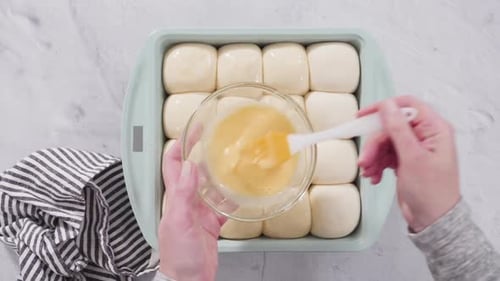 Brushing Egg Wash on Soft Bread Rolls