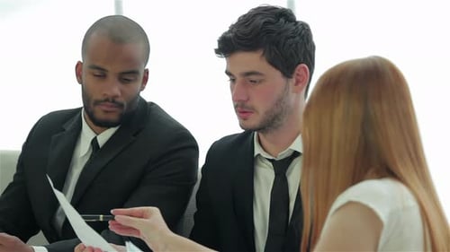 Businessmen Sitting at Table in Office While Discussing Their Business Doings