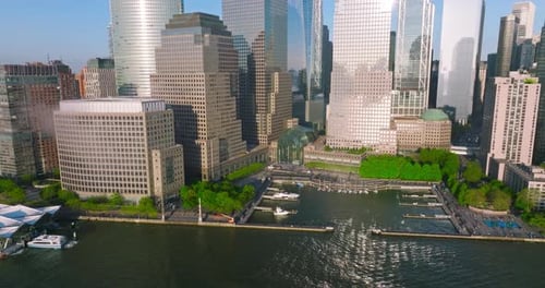 Little yachts dock near Manhattan Island. Skyscrapers shining in the sun