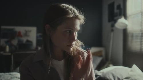 Woman Using Phone In Bedroom, Looking Downcast