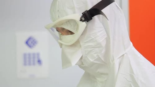Man in hazmat suit works in clean lab