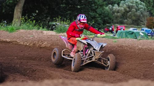 Quad Motorbike Competitors Turn on Curvy Dirt Road on High Speed in Slow Motion