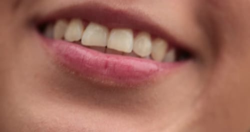 Close-up of girl lips smiling. Macro of young woman smile