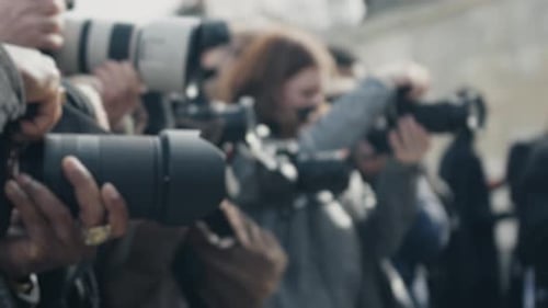 Crowd of Photographers with Professional Cameras Outside