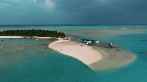 Aerial view of clear water and white sand on Onok Island in the Philippines.
