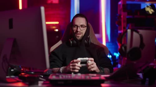 Young Adult Gaming with Console in Neon Room