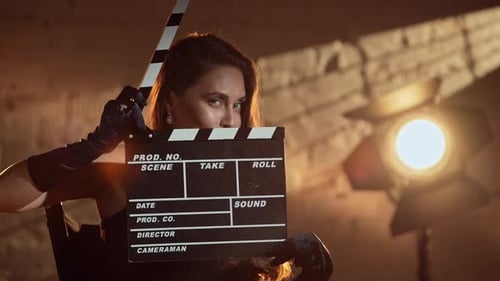 Glamorous Woman with Film Slate in Studio