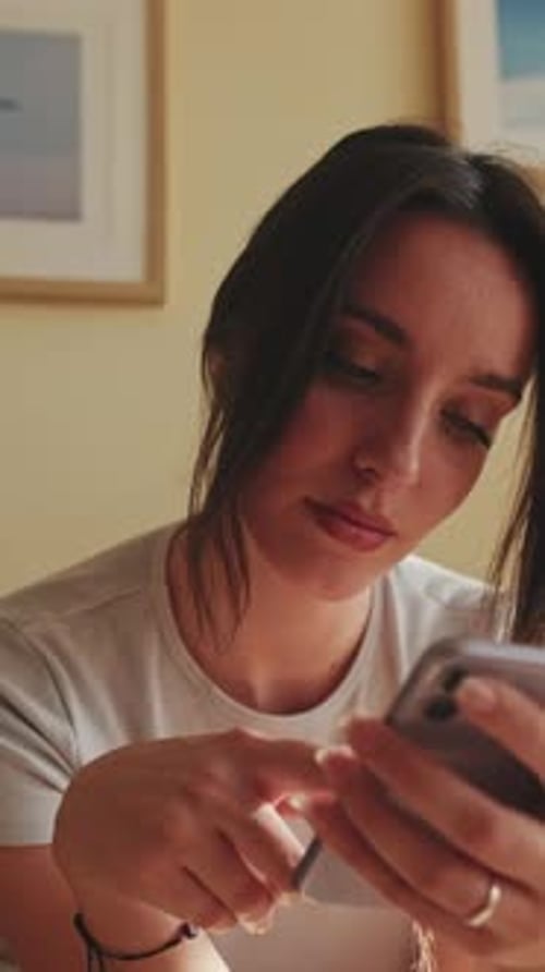 Close up, young woman using mobile phone for texting and scrolling