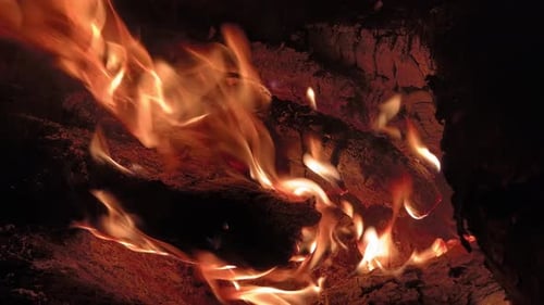 CloseUp of Intense Swirling Flames on Burning Wood Logs