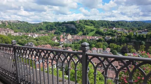 Walking along metal fence, panoramic view of Fribourg, Switzerland.