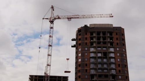 High Crane Against Cloudy Sky