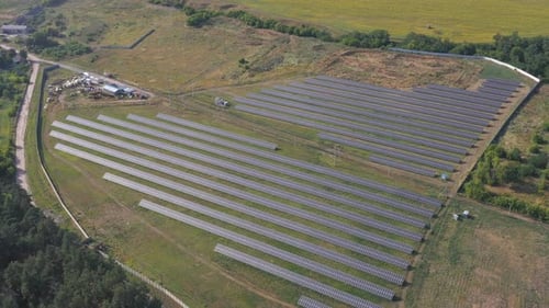 Aerial Shot of Rows of Energy Solar Panels Installed on Farmland Meadow or Rural Field Solar Panel