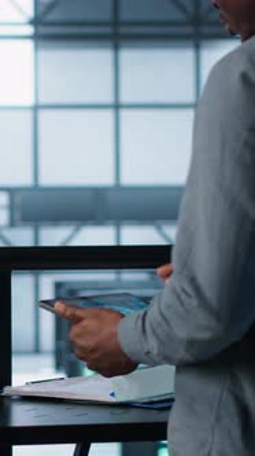 Young Adult Works on Laptop and Tablet