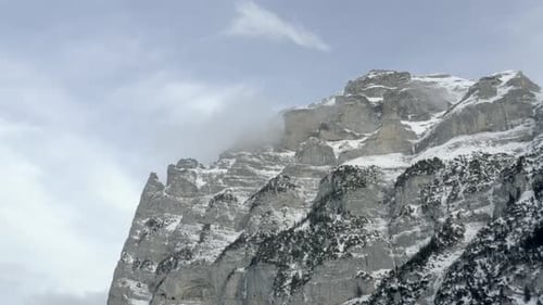 Drone Aerial of Lauterbrunnen surrounded by the Mountain Eiger in the swiss alps. The winter in Swit