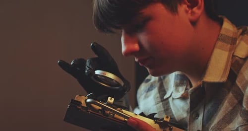 Young Adult Examining Computer Hardware Close Up