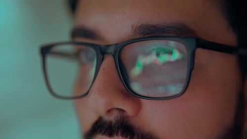 Trader Broker Investor Analyzing Stock Trade Market in Glasses with Reflection