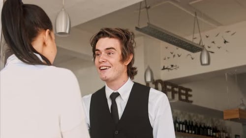 Medium Video of Waiter/ Hostess Welcoming Customer and Showing Them Where