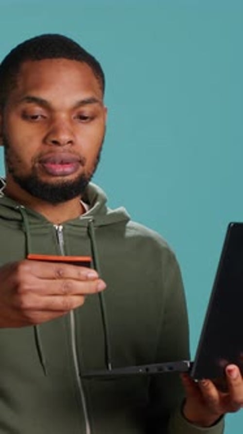 Vertical Video Man Adding Payment Method on Website Using Laptop