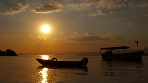 Boats Silhouetted at Golden Hour on Water