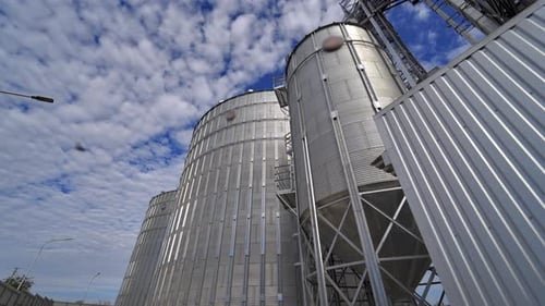 Modern granary outdoors. Metallic elevators for storing grain.