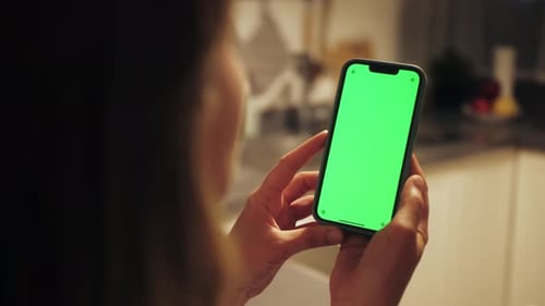 Woman at Modern Apartment Using Phone with Green Screen Chroma Key Surfing Internet