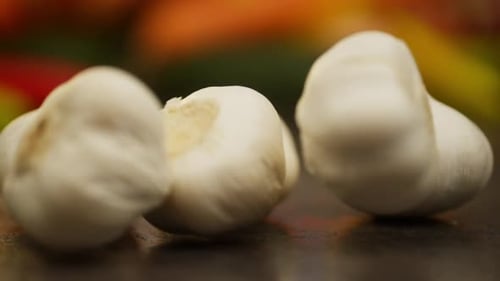 Heads of Garlic Slowly Roll Onto the Table