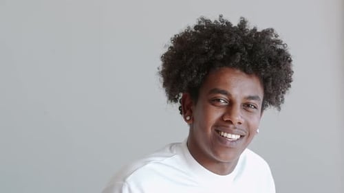 Young man smiling confidently in studio portrait