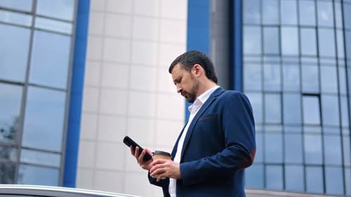 Confident Male Boss Manager in Suit Use Smartphone App Going with Morning Coffee Downtown Street
