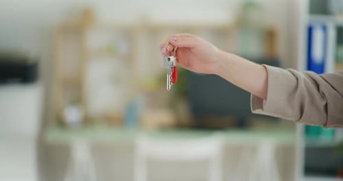 Real Estate Agent Hands Over Keys to New Apartment