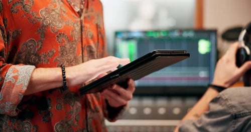 Hands, man and typing on tablet in recording studio for online or internet research for lyrics as